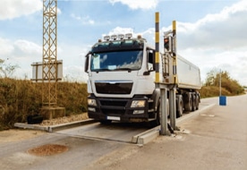 LKW auf mobiler Wiegeplattform von Pfreundt für genaue Gewichtsmessung. Perfekt für Bau- und Transportbranchen.